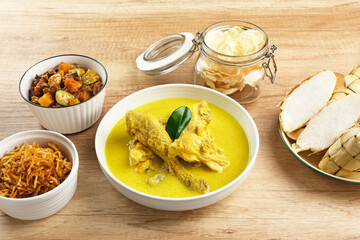 Opor Ayam, served with ketupat, sambal goreng ati, keripik kentang and emping. Popular during Eid al Fitr. Indonesian traditional food
