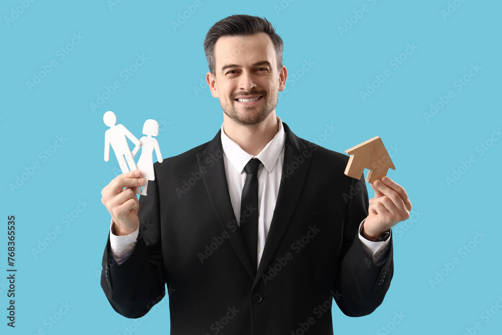 Sticker portrait of male real estate agent with house model and paper human figures on blue background