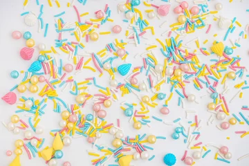 Keuken spatwand met foto Sweet colorful sprinkles scattered on white background © Pixel-Shot