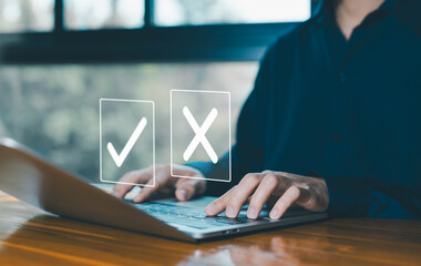 true and false symbols agreeing, check right and wrong marks on a laptop. concept decide to choose...
