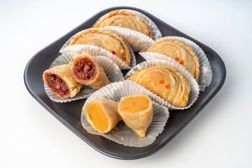 Curry puff on black plate on white background, Curry puff pastry on white background.