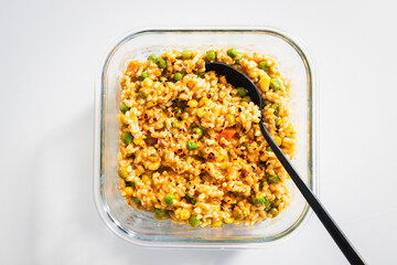 risotto primavera with peas and corn in meal prep container