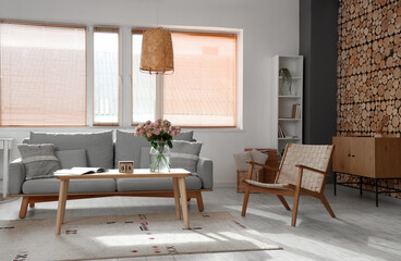 Interior of living room with sofa and roses in vase. International Women's Day