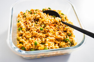 risotto primavera with peas and corn in meal prep container