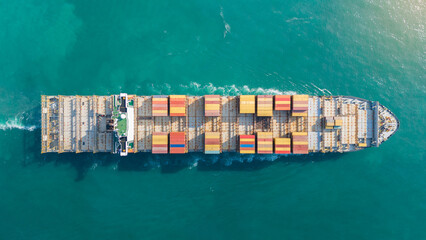Aerial view of cargo ship with contrail in the ocean sea ship carrying container and running from container international port smart freight shipping by ship service - obrazy, fototapety, plakaty