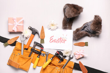 Composition with construction tools, greeting card, gifts and Easter decor on light background
