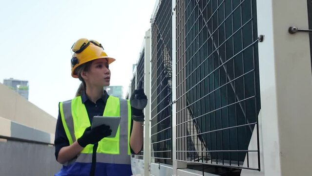 Female woman lady girl person people human walking check up technology construction engineer yellow orange hardhat safety examing technology tablet report professional businesswoman factory expertise