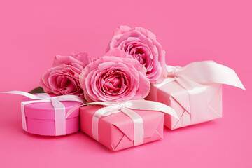 Gift boxes and beautiful roses on pink background