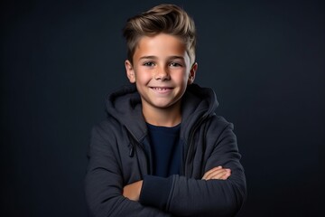 Portrait of a handsome boy on a dark background. Kids fashion. - obrazy, fototapety, plakaty