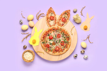 Board of tasty Easter pizza with bunny ears, eggs, cheese and mimosa branches on lilac background