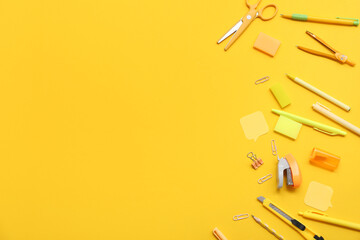 Different stationery on yellow background. Top view