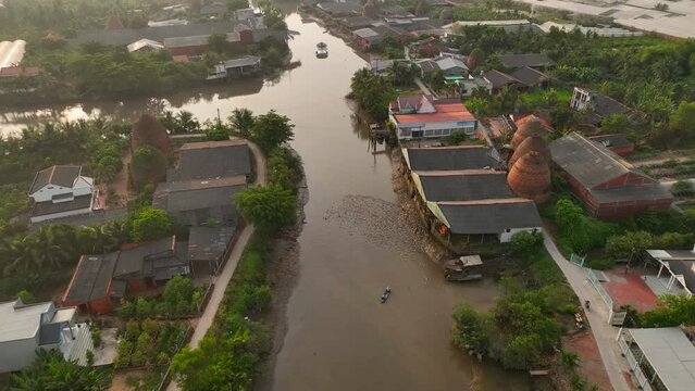 Brick kilns and pottery kilns growing close together, from a distance, look like flaming towers under the sun, in Mang Thit, Vinh Long province, Viet Nam