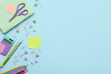 Different stationery on blue background. Top view
