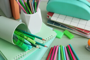 Pencil holders and notebooks on table. Closeup