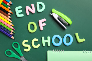 Text END OF SCHOOL, pencils and stapler on green background. Top view