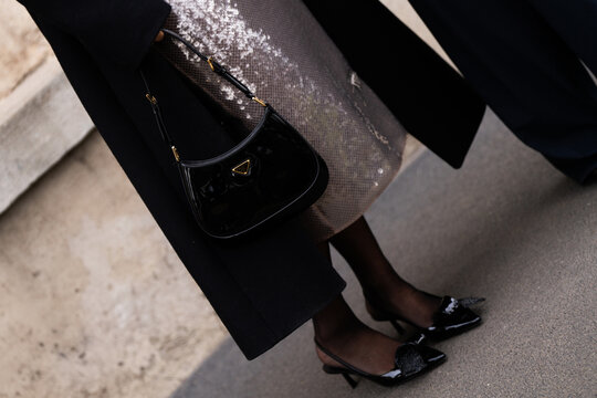 Milan, Italy - January, 14, 2024: man wears Cleo bag from Prada and leather slingback pumps, street style handbag details, fashion outfit detail
