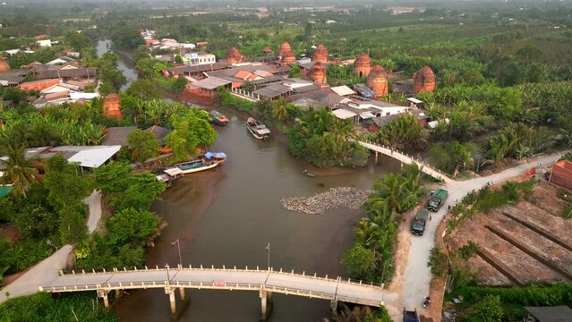 Brick kilns and pottery kilns growing close together, from a distance, look like flaming towers under the sun, in Mang Thit, Vinh Long province, Viet Nam