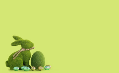 Easter bunny and egg made of grass on green background