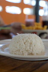Cooked jasmine rice in dish, providing energy in every meal.