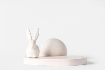 Decorative podiums with toy bunny on white background. Easter celebration