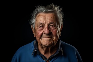 Portrait of an old man on a black background. Studio shot.