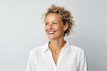 Portrait of happy mature woman smiling against grey background with copyspace - obrazy, fototapety, plakaty