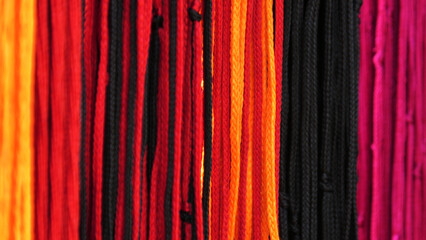 In a shop selling colorful thread strings used for spiritual purposes