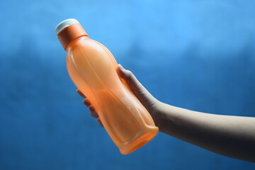 a woman holding a drinking water bottle
