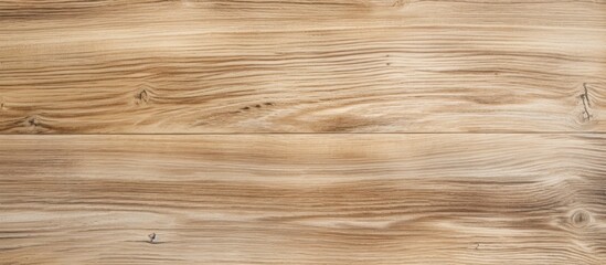 Fototapeta premium A close up of a brown wooden floor with a blurred background, showcasing the rich amber tones of the hardwood plank flooring and varnish finish