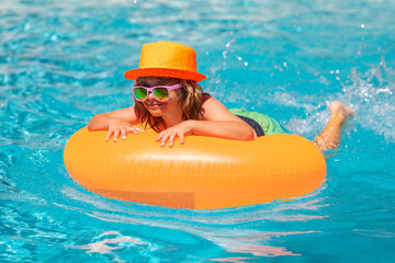 Funny kids summer face. Child swim in swimming pool. Water sport activity on summer vacation with children.