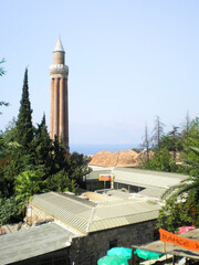 Obraz premium Antalya, Turkey, August 08, 2007 : Roofs of the old city market and the perfectly preserved famous ancient Yivli Minaret in the old city of Antalya in Turkey