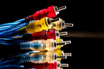 Tricolor RCA cable for audio and video, RCA cable isolated on black background