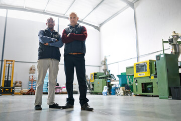 Business, manager and teamwork with arms crossed in warehouse with portrait, confidence and...