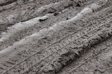 Car wheel tracks in liquid mud