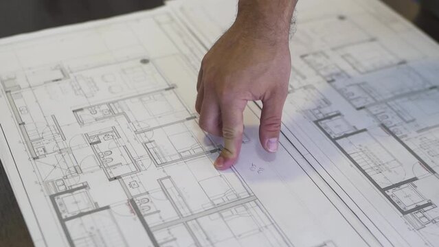 Revealing the plan of a future home, an architect moves his finger across the blueprint, making blueprints come alive