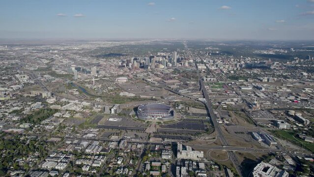 An orbiting 4K drone shot of Empower Field, the NFL stadium that is home to the Denver Broncos, with the Mile-High City skyline in the distance.