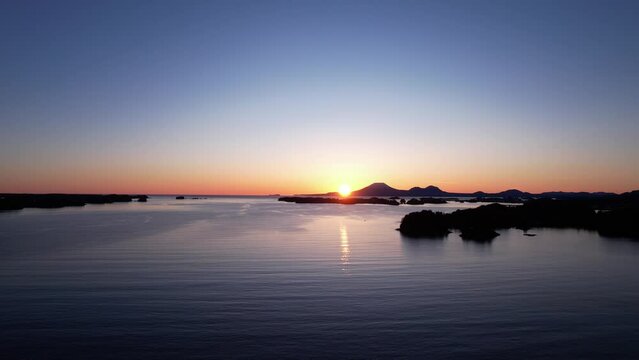 4k 23.98fps aerial video of beautiful Sitka, Alaska.  Pacific Ocean winds through mountainous islands.  Mount Edgecumbe in the background, at sunset. March of 2024.