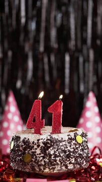 Burning candles numbers 41 on cake. Birthday cake for forty-first years old. Slow Motion. Copy space.