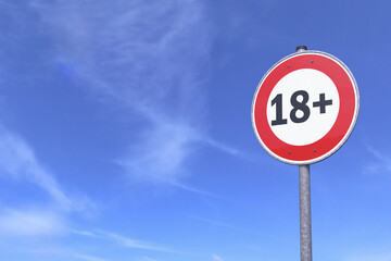 3d rendering of a traffic sign - 18 sign warning symbol - In the background a blue sky with clouds. 18 plus - censored - eighteen age older adult content. - 768432117