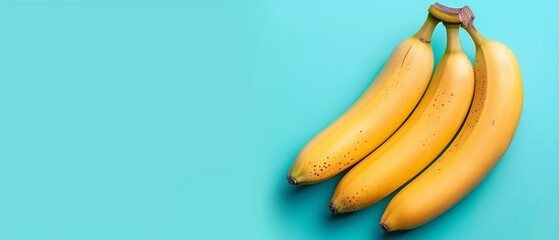   A trio of bananas rests atop a blue table, beside a pair of yellow bananas also positioned on a blue table