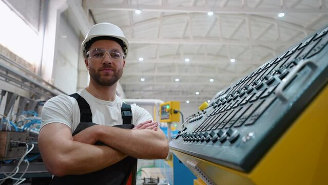 Portrait of engineer operator near CNC machine in factory industries
