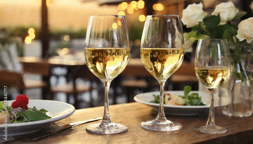 Wall mural glasses of champagne on table, Glasses of white wine served on table in restaurant