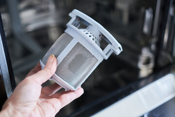 Dishwasher filter, close-up. Dishwasher repair.