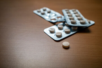 Cream tablets pills drugs on wooden table. Medicine concept