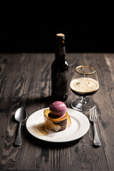 restaurant ice cream served with bottle of beer and glass in dark mood