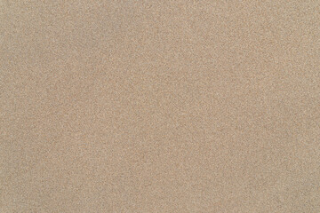 Smooth untouched fine sand on a beach on a sunny day, viewed from above. Abstract textured natural...