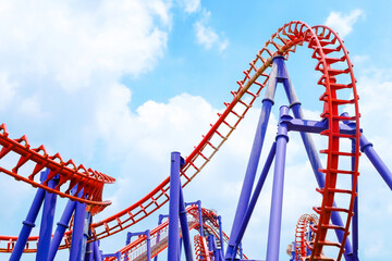close-up image of a roller coaster track and the blue sky