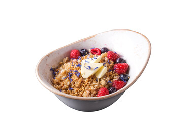 Oatmeal with berries and nuts. Porridge with raspberry, blueberry, nuts and butter in a plate. White background. Healthy breakfast  concept