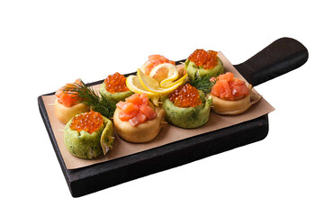 Pancake rolls with curd cheese, caviar and salmon on wooden board isolated on white