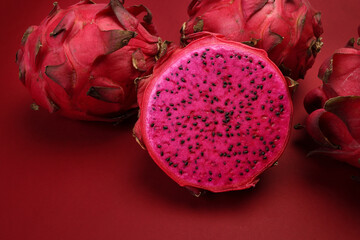 Ruby red exotic cactus dragon fruit whole cut half on red background - 768483782